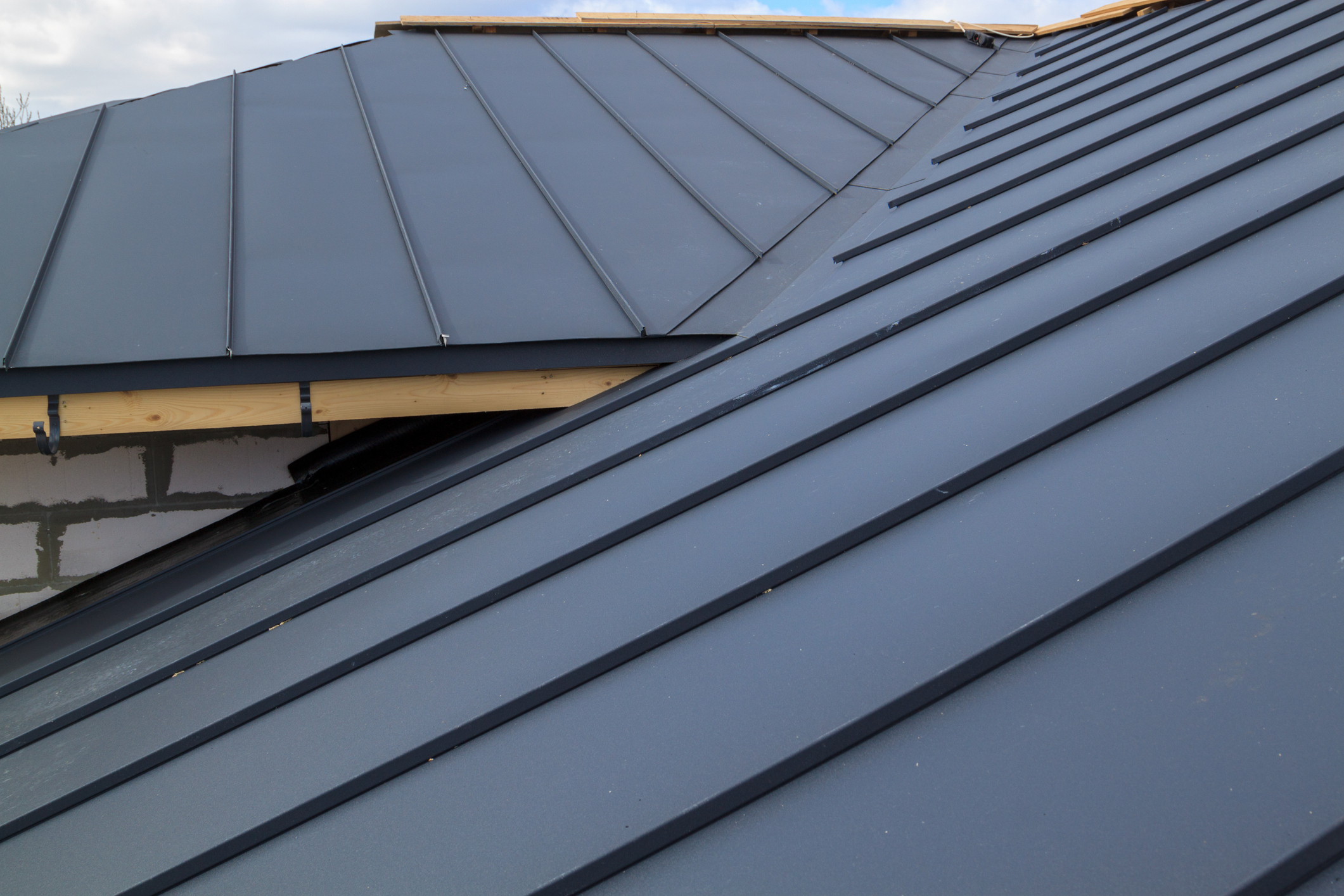 Close Up View Of House Under Construction With Grey Folding Roof On Waterproofing Layer Close Up View Of House Under Construction With Grey Folding Roof On Waterproofing Layer